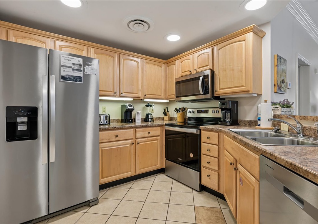Your fully equipped kitchen features granite counters, stainless appliances, and warm wood cabinets for effortless home cooking.