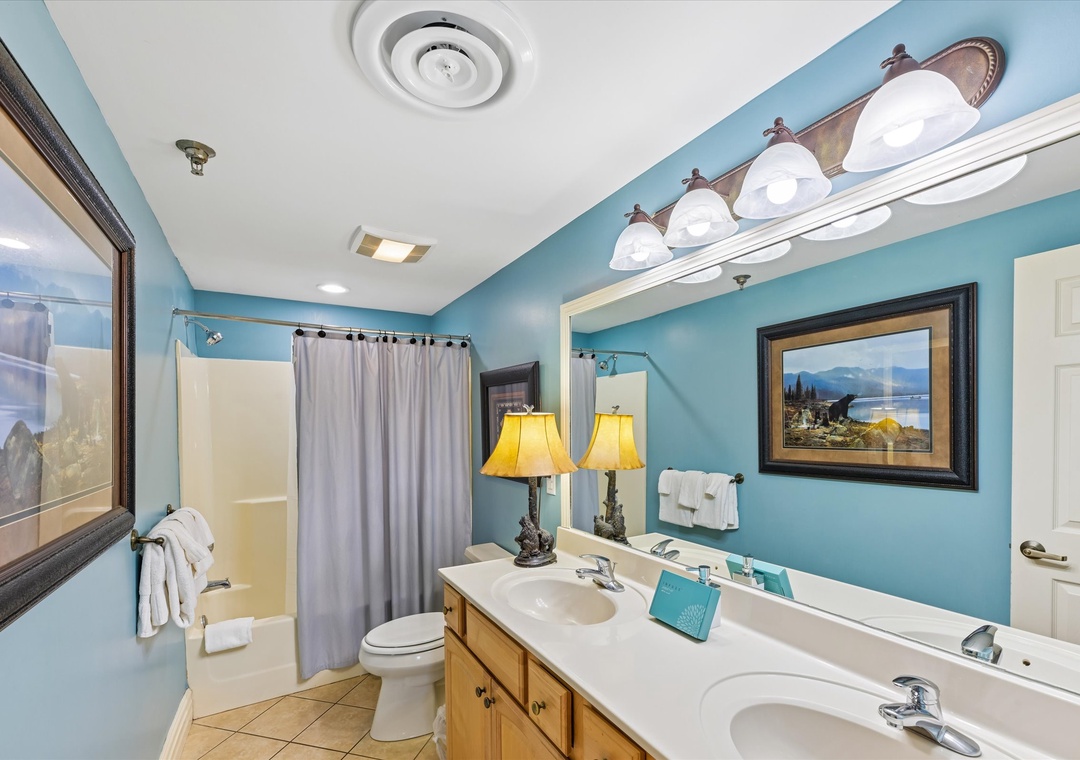 Guest bathroom with shower/tub combo and dual vanities