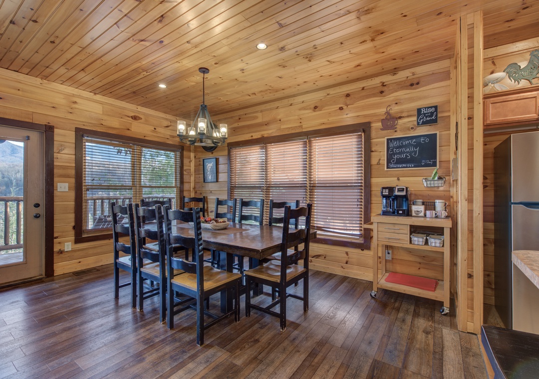 Gather around the handcrafted dining table in this warm, wood-paneled cabin retreat. Natural light streams through the windows, highlighting the cozy charm and thoughtful touches that make your mountain getaway feel like home.