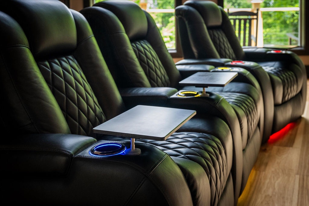 Sink into plush recliners with built-in cup holders and tabletops—your perfect spot for movie nights or unwinding with a good book.