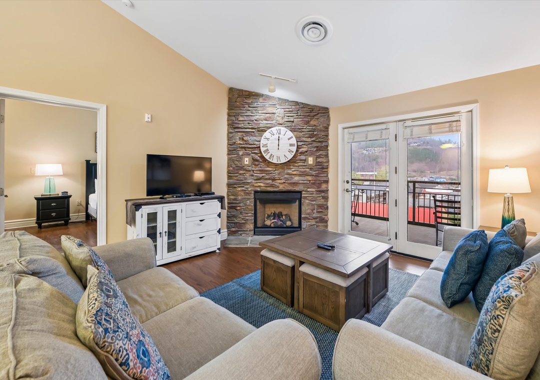 Sink into plush sofas by your crackling fireplace while mountain views unfold through floor-to-ceiling windows on your private balcony.