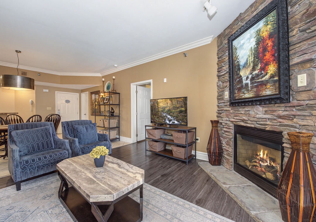 Curl up in your cozy living room where flickering firelight dances across stone walls, creating the perfect atmosphere for relaxing evenings.