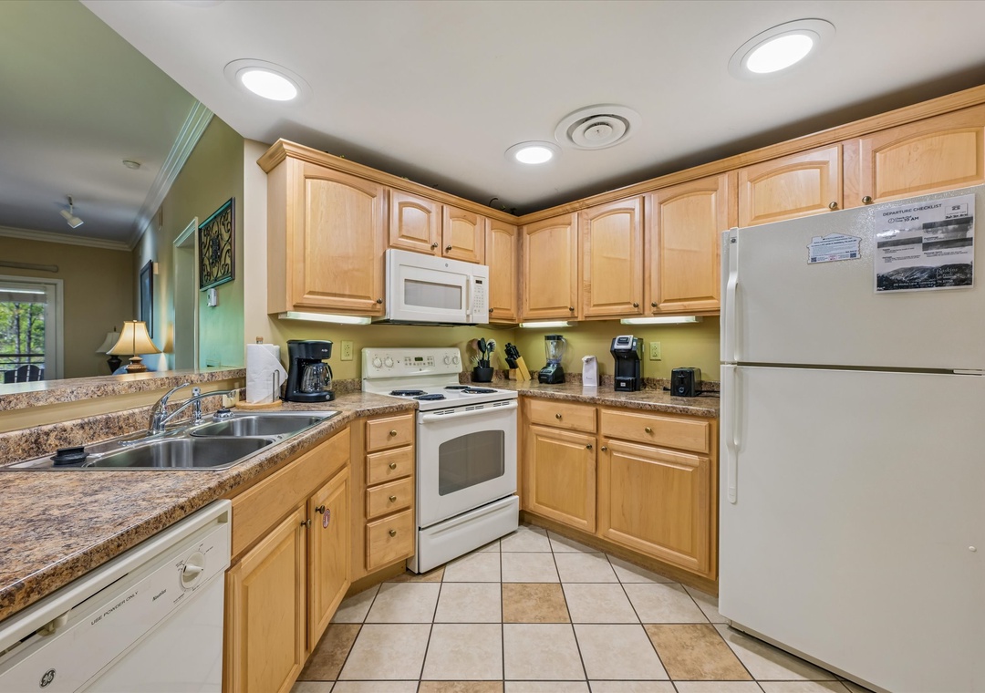 Whip up your morning coffee in this fully-equipped kitchen with granite counters, modern appliances, and everything you need for a perfect home-cooked meal.