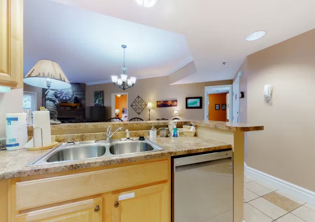 Your fully equipped kitchen features granite counters, dishwasher, and opens to a comfortable living space perfect for gathering.