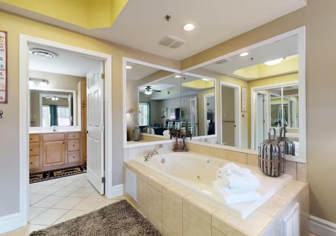 Unwind in your private jetted tub surrounded by mirrors and soft lighting, with plush towels awaiting your relaxing soak.