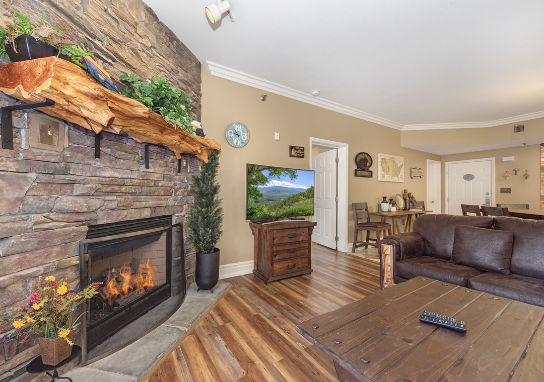 Cozy up by your crackling fireplace while enjoying mountain views on the flat-screen TV in this rustic-chic living room.