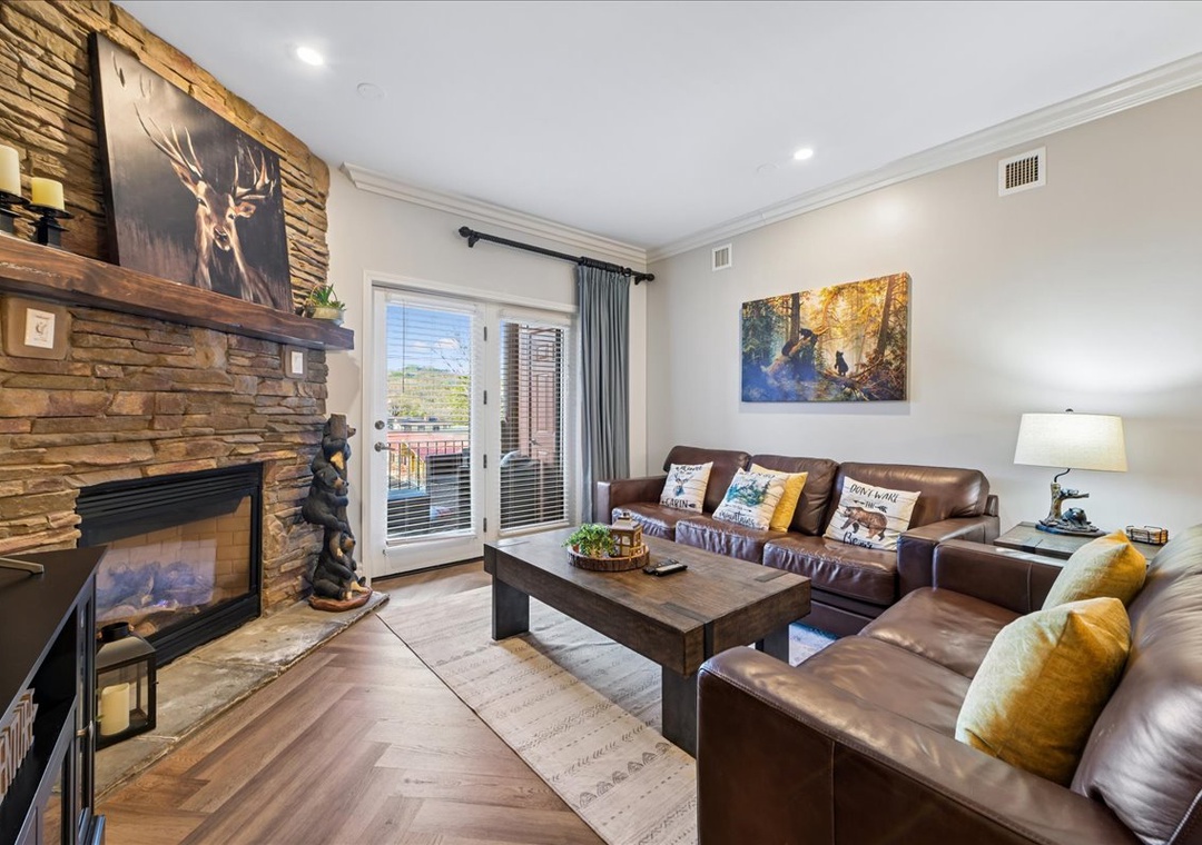 Sink into luxurious leather seating by your stone fireplace, where rustic charm meets modern comfort in your mountain-inspired living room.