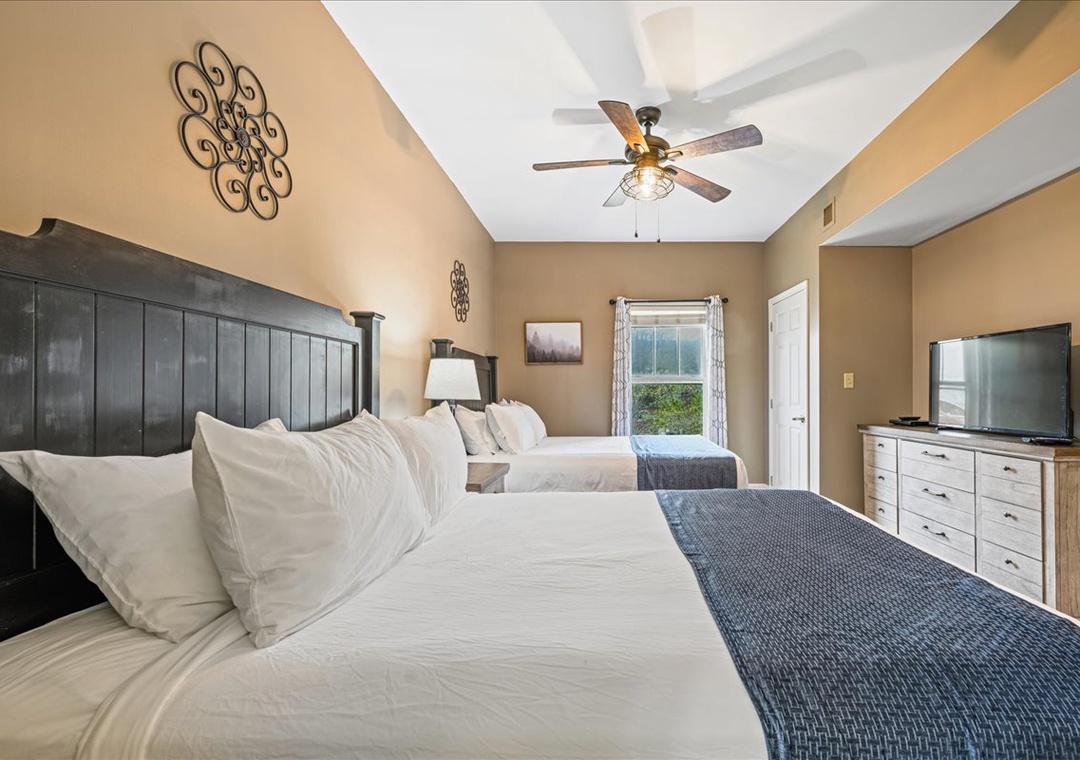 Sink into crisp white linens in your spacious bedroom, where twin beds and warm decor create the perfect retreat for restful nights.