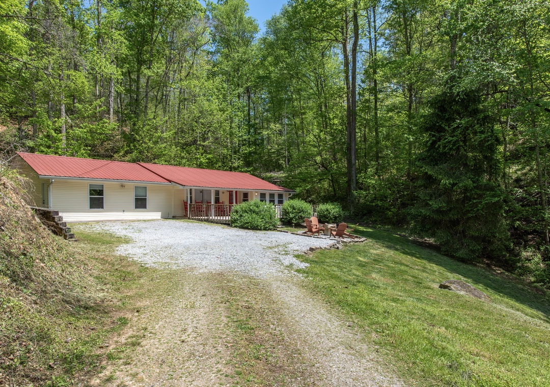 Private forest retreat with gravel parking and peaceful wooded surroundings perfect for a nature getaway.