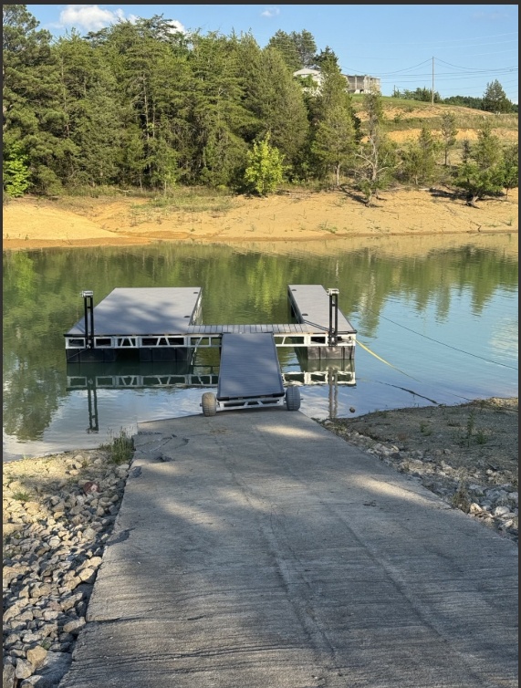A private dock leads to calm, reflective waters—perfect for morning swims, fishing, or launching kayaks into the peaceful lake surrounded by natural beauty.