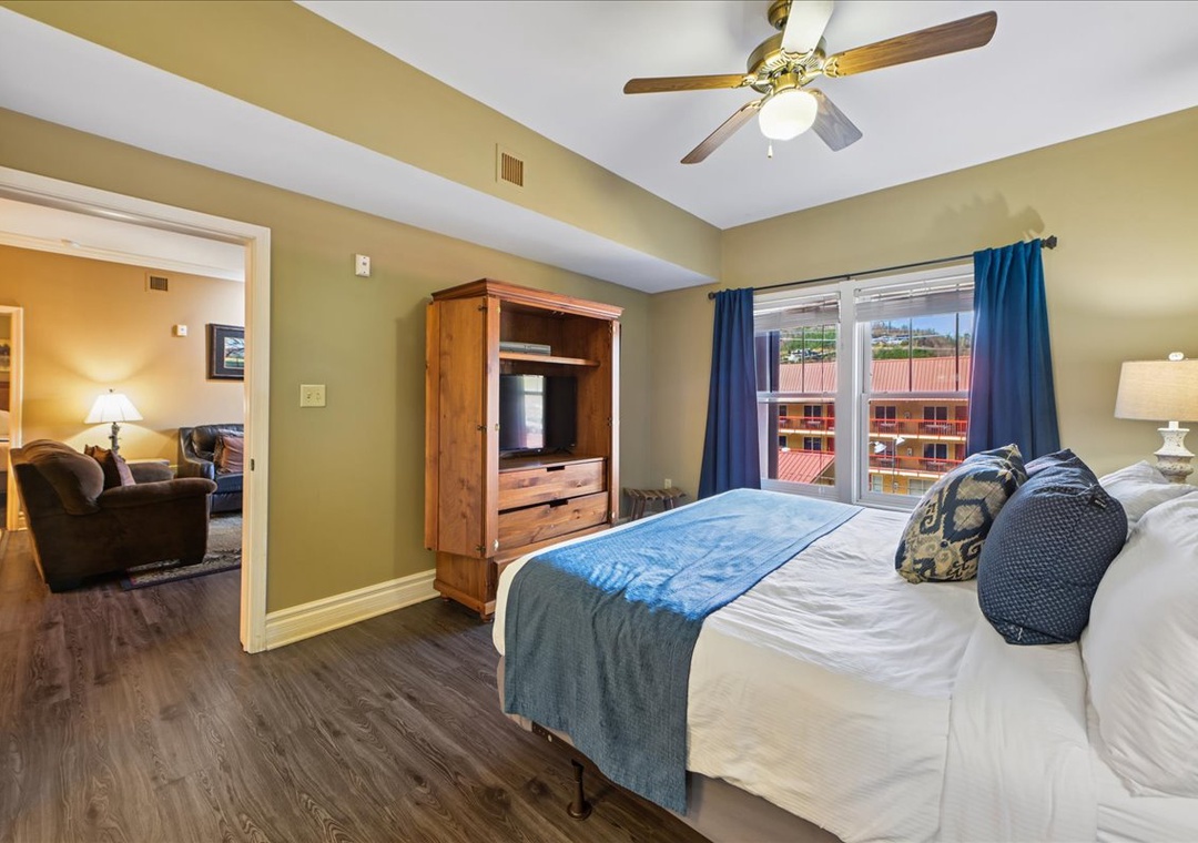 Unwind in your spacious bedroom with comfortable bedding, entertainment center, and peaceful mountain views from your private window.