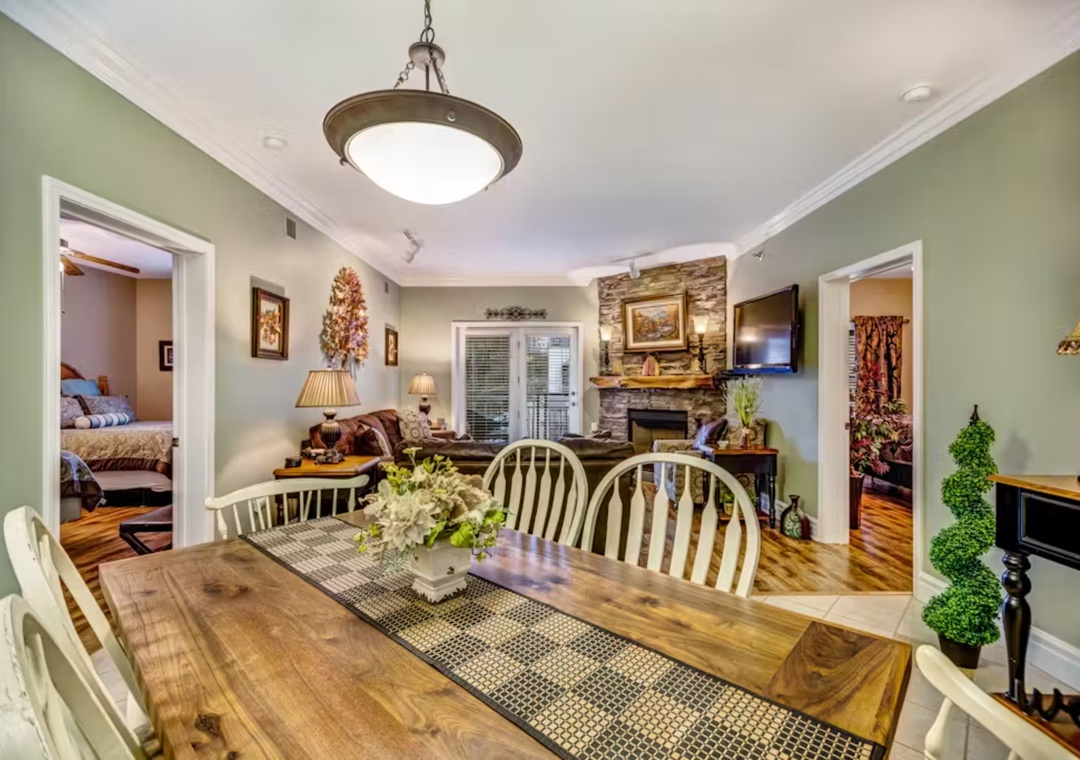 Gather around the rustic dining table for memorable meals with your loved ones in this cozy, open living space.