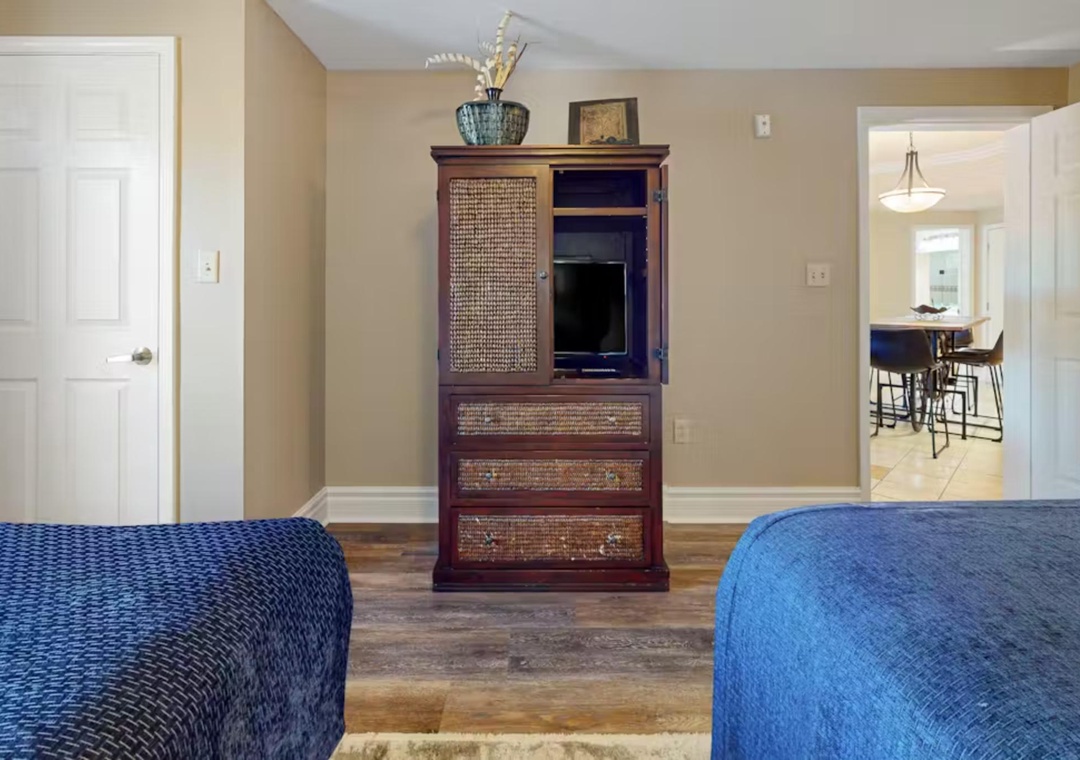 Relax in your spacious bedroom with twin beds, elegant furniture, and TV entertainment after exploring the area.