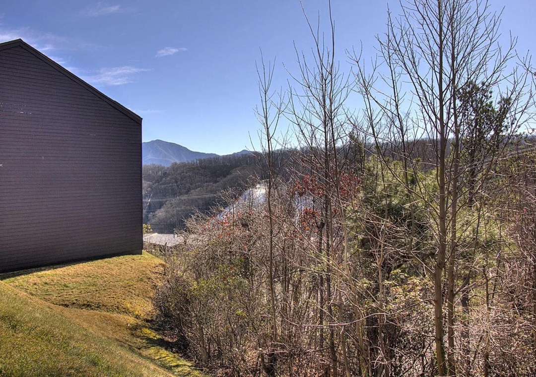 Mountain views stretch across rolling hills from this peaceful property location surrounded by natural landscape.