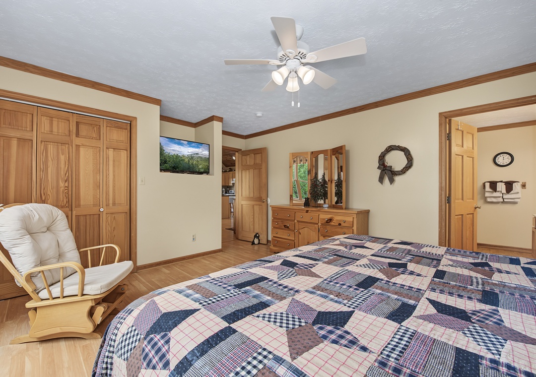 Unwind in your peaceful retreat, where warm wood tones, a cozy rocking chair, and soft natural light create the perfect space for restful nights and lazy mornings.