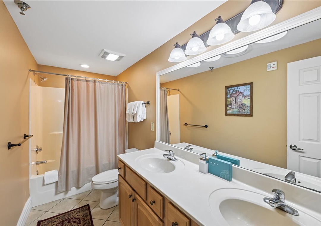 Your spacious bathroom offers dual sinks, a relaxing tub-shower combo, and warm lighting for your perfect morning and evening routines.