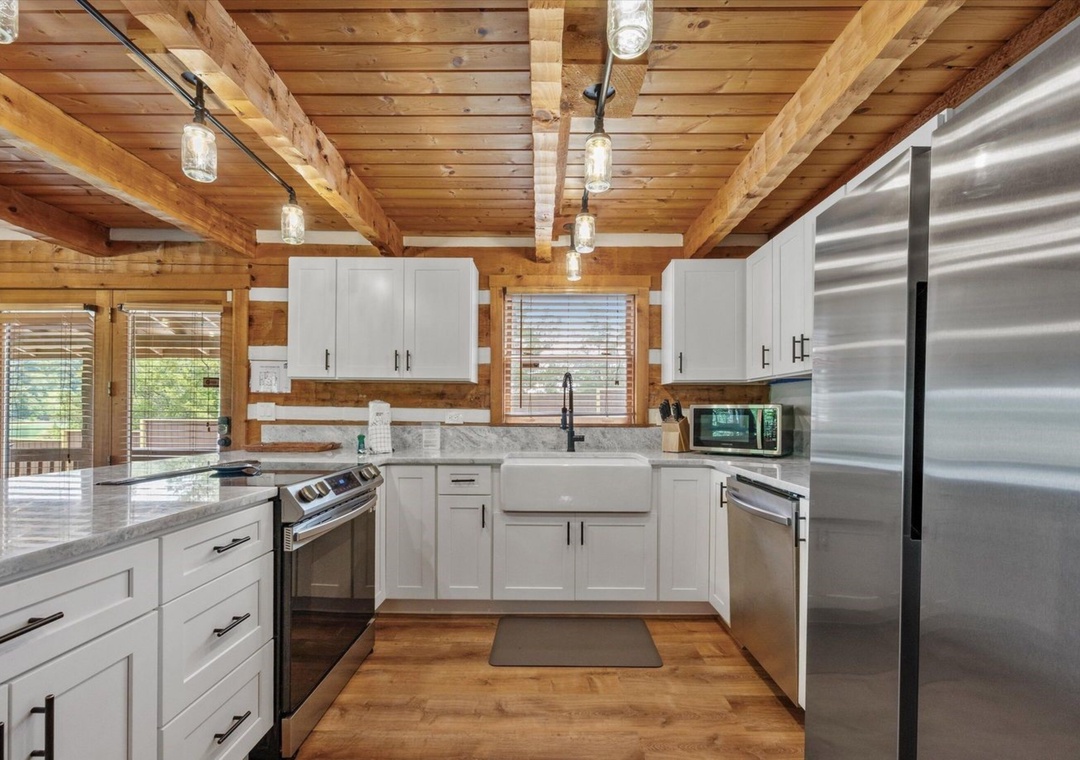 Your gourmet kitchen features stainless steel appliances, marble countertops, and exposed wood beams creating a perfect blend of rustic charm and modern convenience.