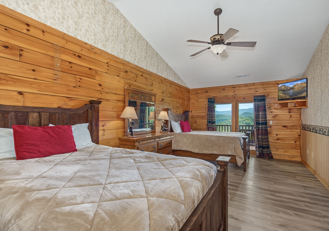 Drift off in your cozy cabin-style bedroom with stunning mountain views framing your mornings. Natural pine walls and gentle ceiling fans promise restful nights, while your private balcony invites you to breathe in the fresh mountain air.