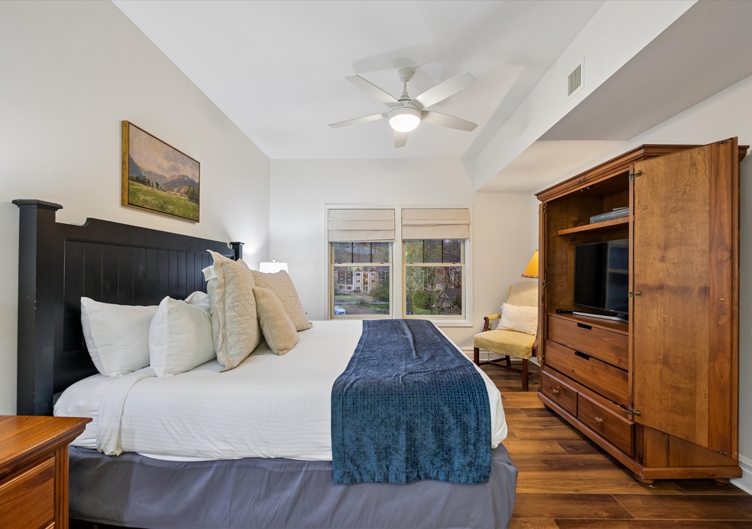 Unwind in your serene bedroom sanctuary with plush bedding, warm wood furnishings, and peaceful views that invite restful nights.