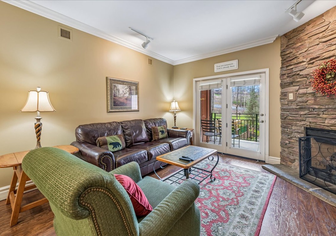 Cozy up by the stone fireplace while you unwind on plush leather seating in your welcoming living space.