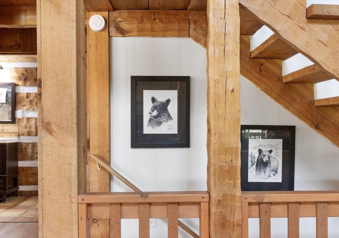 Step into rustic charm where exposed timber beams create a cozy mountain retreat atmosphere, adorned with wildlife artwork.
