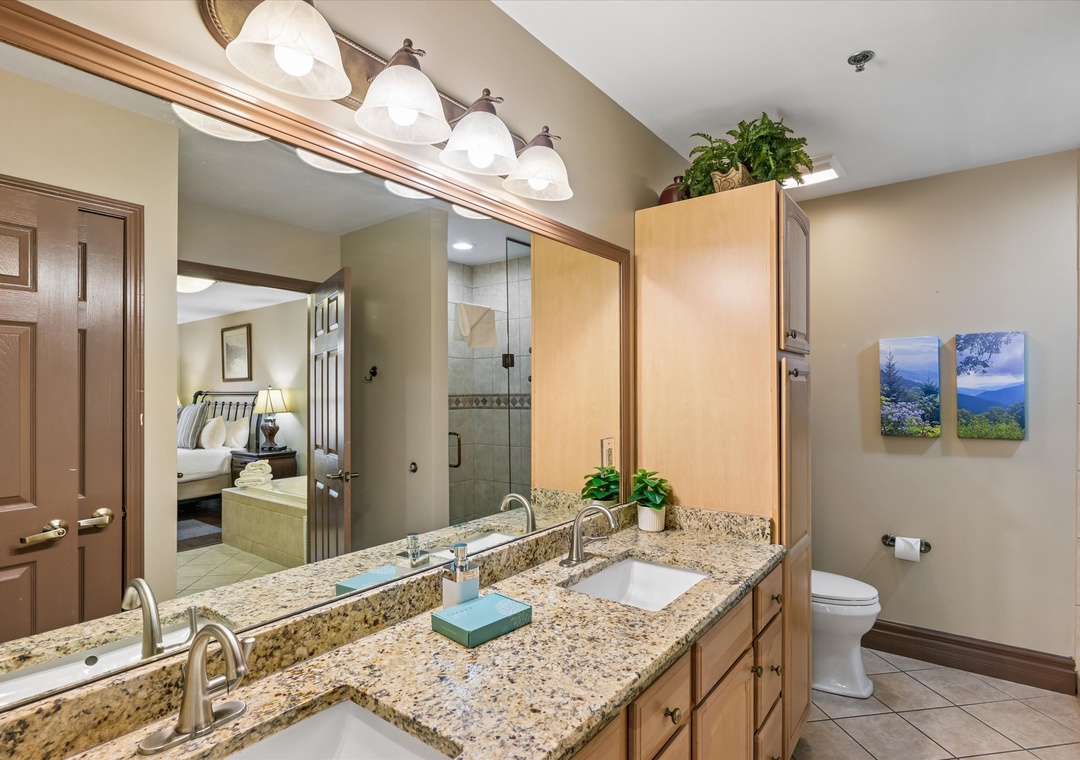 Freshen up in your spacious bathroom with granite counters, dual sinks, and warm wood finishes creating a welcoming retreat.