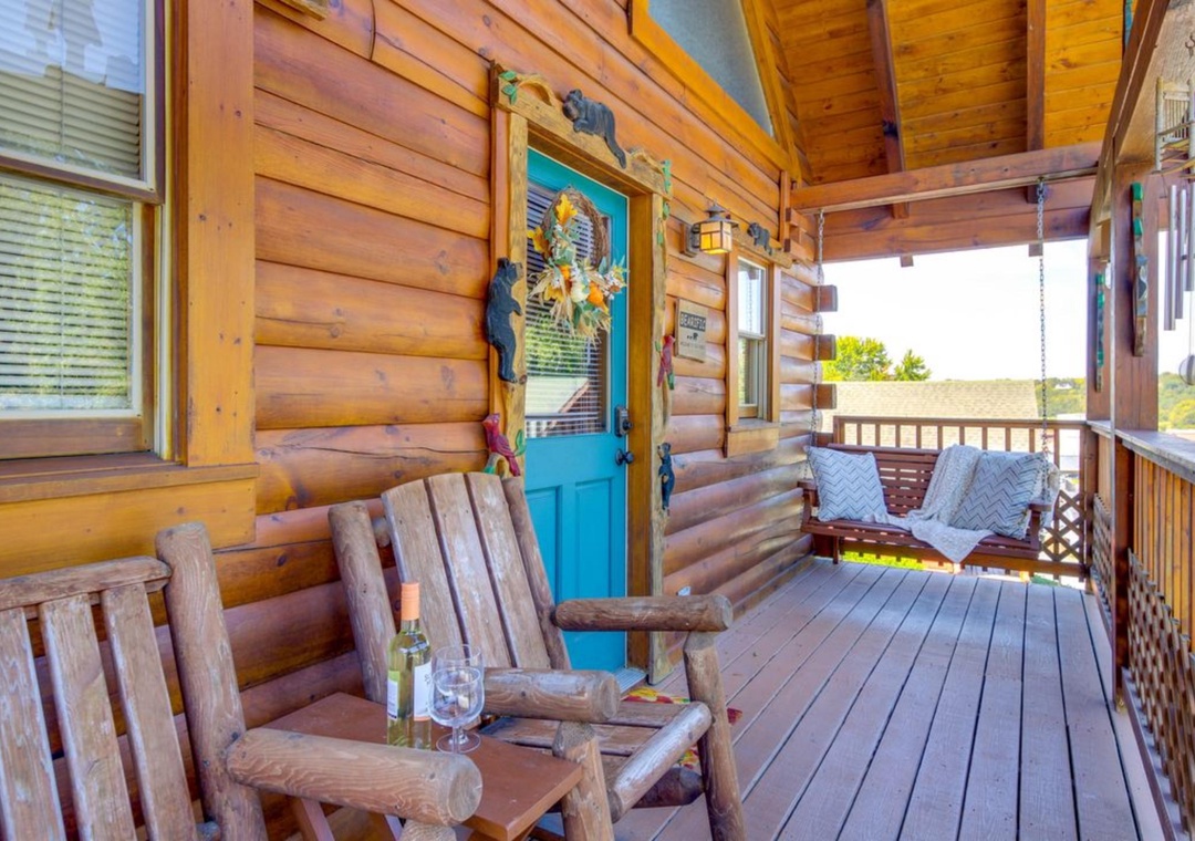 Unwind on your private covered porch with handcrafted log furniture, perfect for morning coffee or evening wine as you soak in peaceful mountain views.