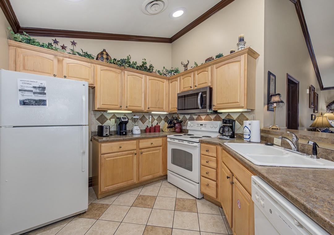 Your fully equipped kitchen features modern appliances and warm wood cabinetry, perfect for preparing meals during your stay.