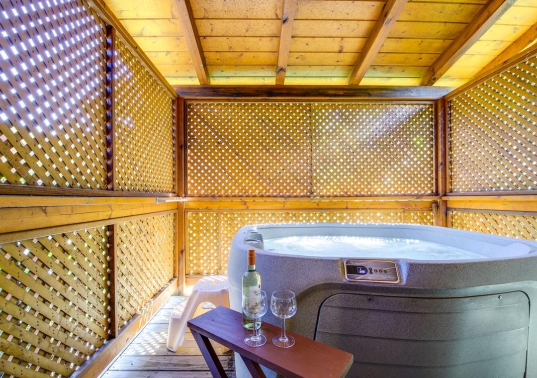 Unwind in your private hot tub sanctuary, where lattice walls create intimate ambiance and wine awaits your evening soak.