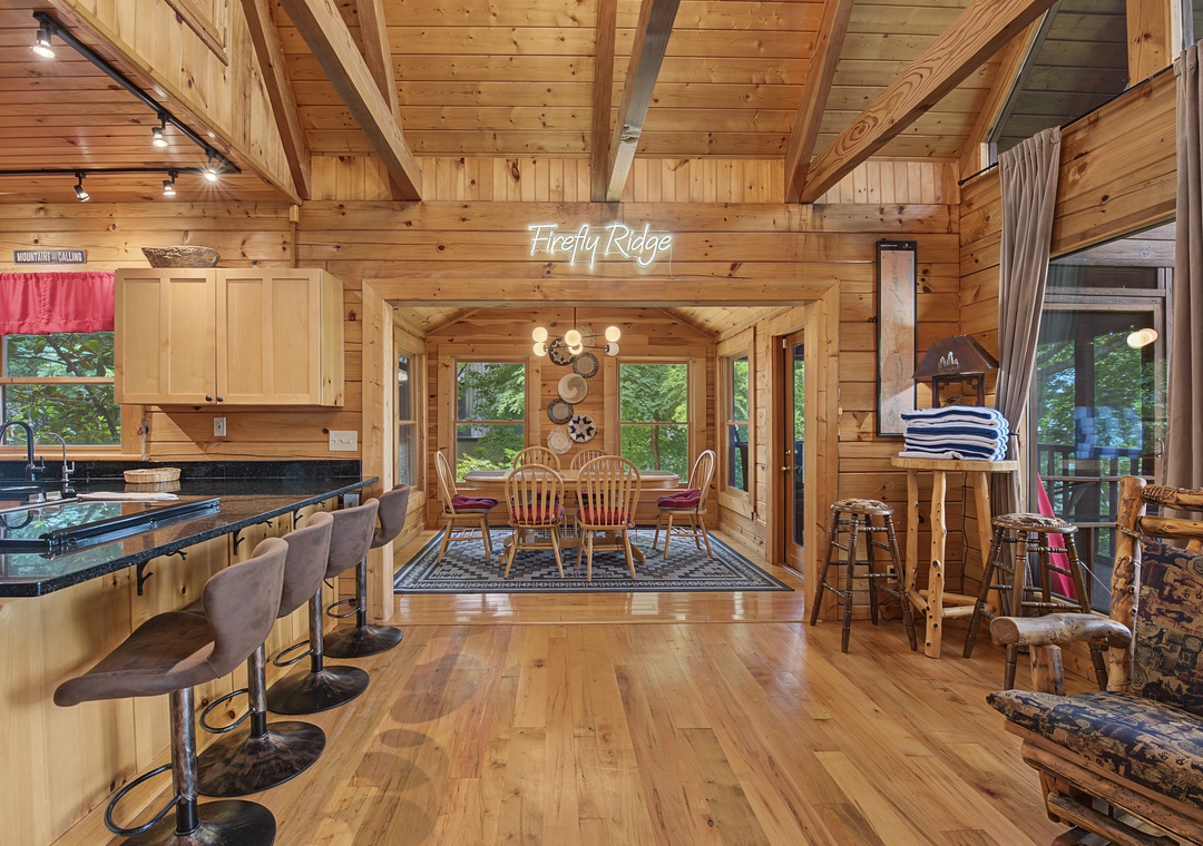 Gather around the granite-topped breakfast bar in your open-concept cabin, where soaring vaulted ceilings and warm wood beams create the perfect mountain retreat for cozy meals and memories.