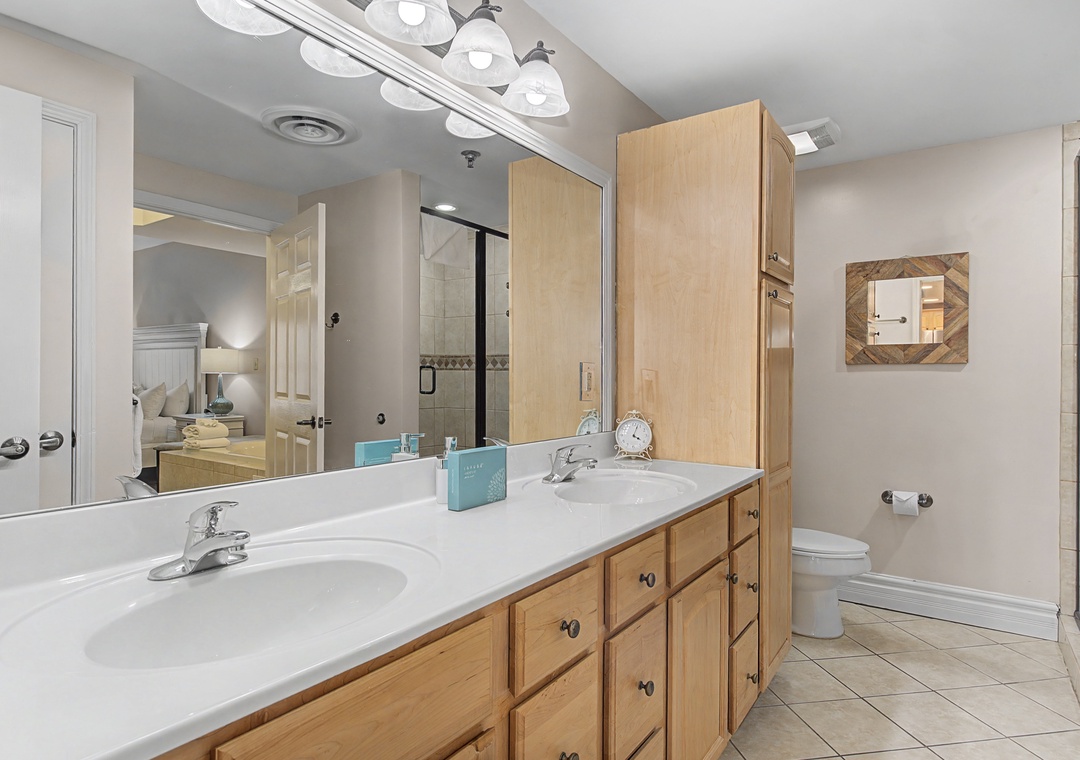 Your spacious bathroom features dual sinks, ample storage, and bright lighting for comfortable mornings and evenings.
