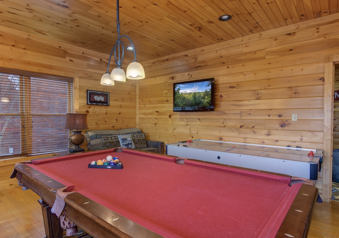 Challenge your friends to a game of pool in this cozy wood-paneled game room, or settle in on the comfy couch for your favorite movie night.