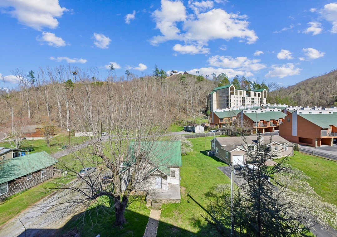 Mountain valley resort community featuring multiple vacation rental buildings nestled among rolling hills and open green spaces.