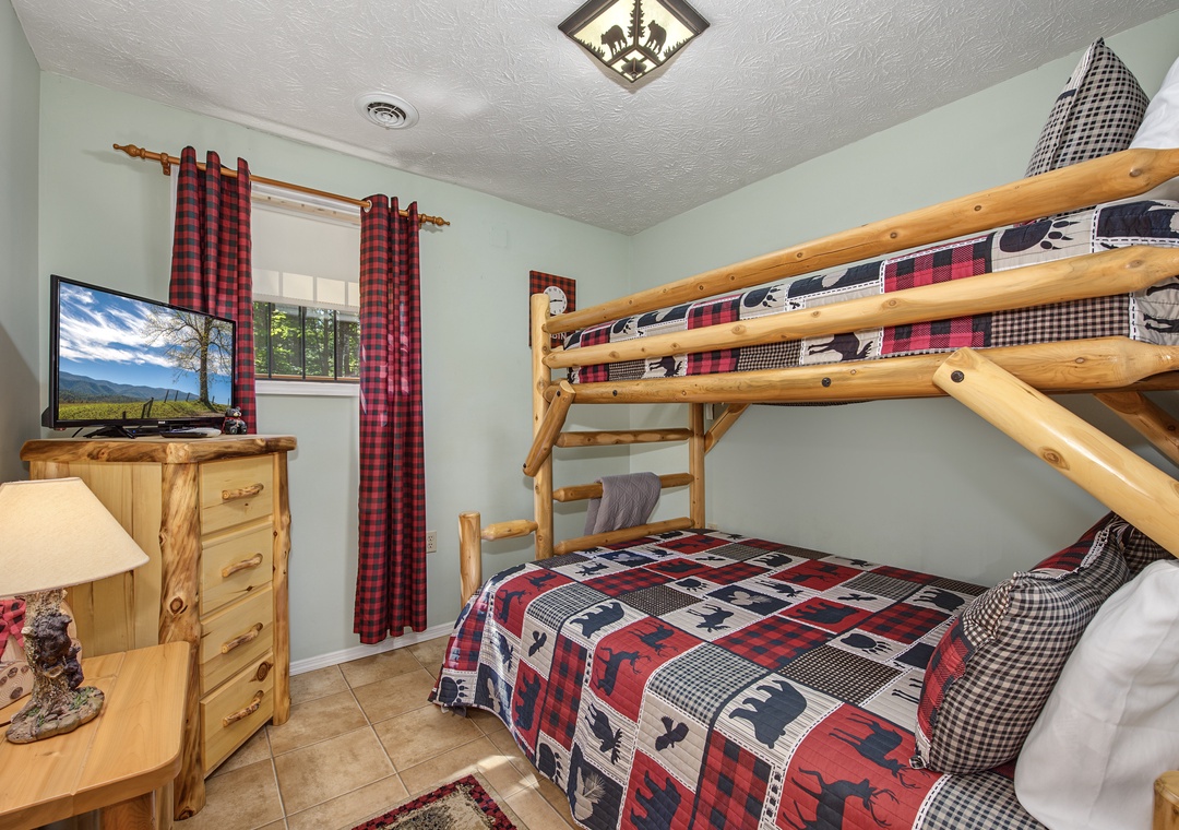 Cozy rustic bedroom with charming log bunk beds and nature-inspired décor—perfect for kids or extra guests. Your family will love the cabin feel and warm mountain touches that make this space uniquely welcoming.