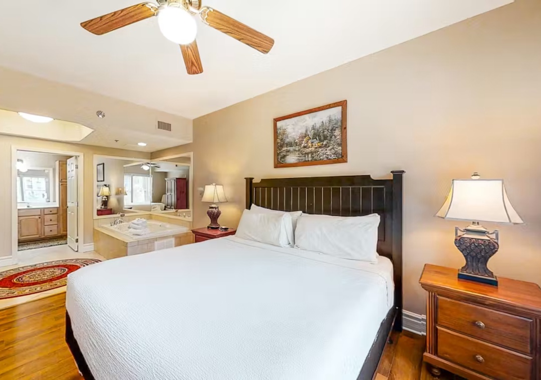 Sink into crisp white linens while your private spa tub awaits just steps away, creating the perfect romantic retreat.