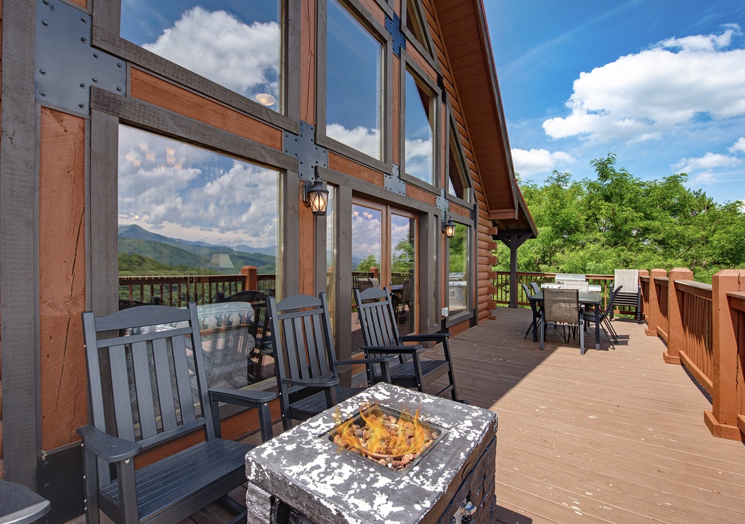 Settle into cozy deck seating with breathtaking mountain views stretching before you—perfect for morning coffee or sunset gatherings amid peaceful natural surroundings.
