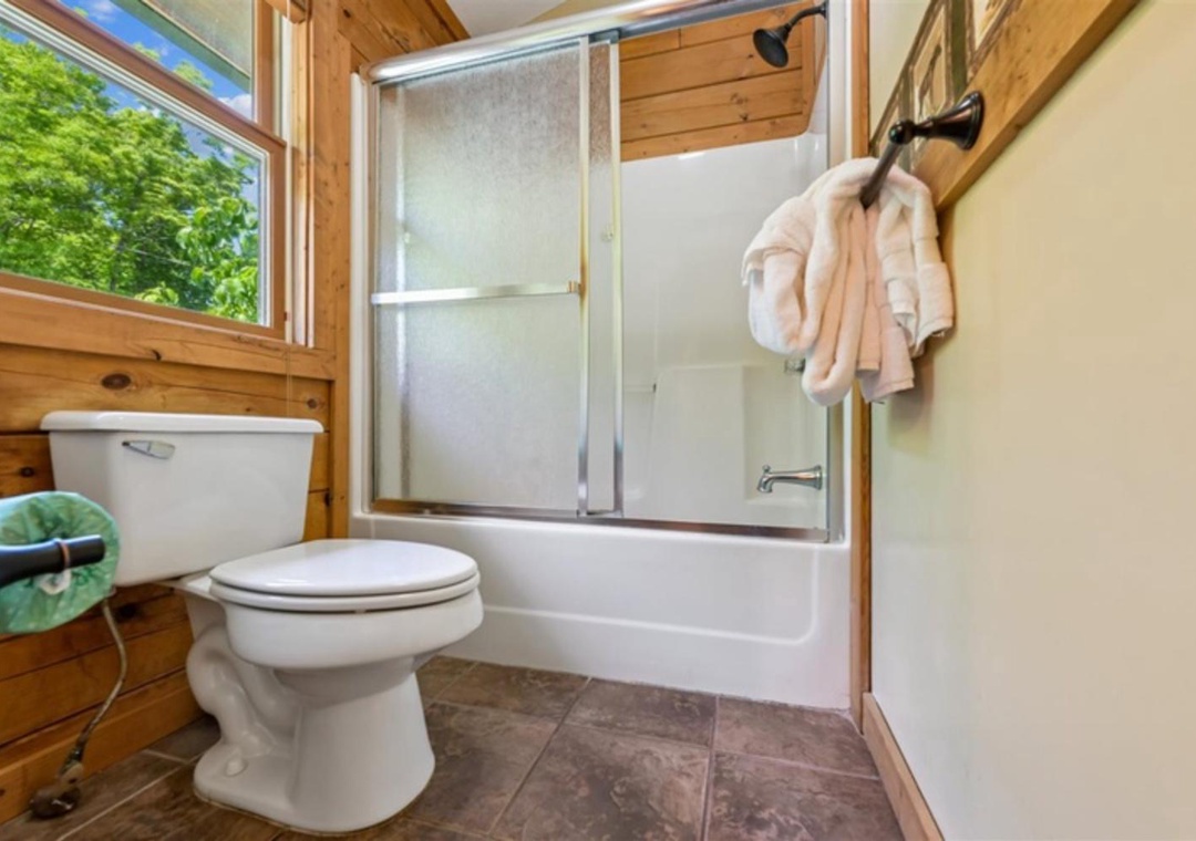 Unwind in your private bathroom with a relaxing tub-shower combo, natural light, and fresh towels ready for you after a day of adventure.
