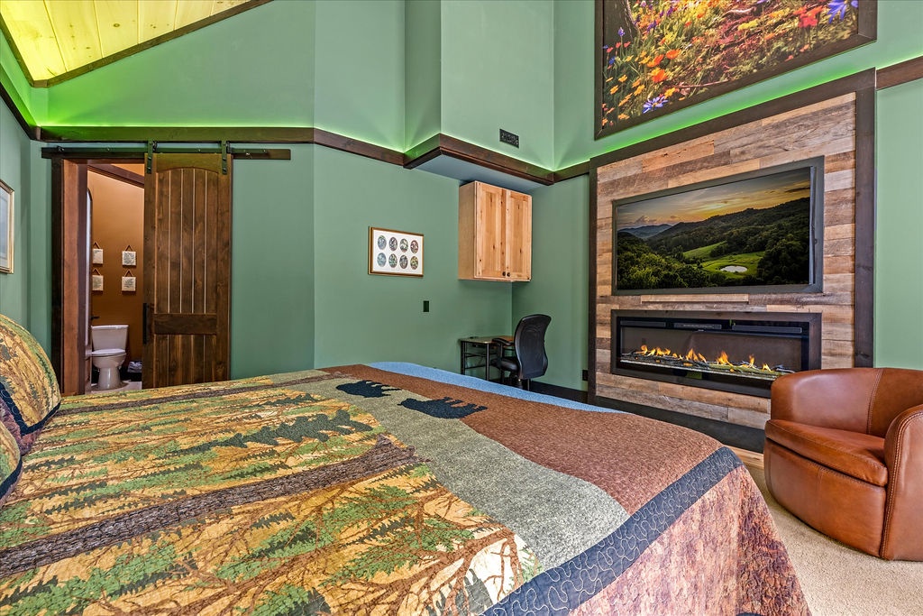 Unwind in your cozy retreat with vaulted ceilings, a crackling fireplace, and mountain views on the flat-screen TV. Your restful escape awaits.