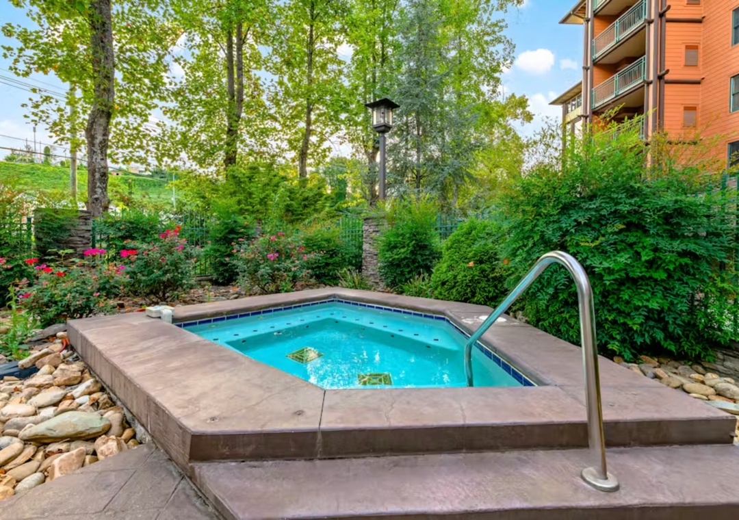 Soak your worries away in this peaceful hot tub, surrounded by lush gardens and blooming flowers for ultimate relaxation.
