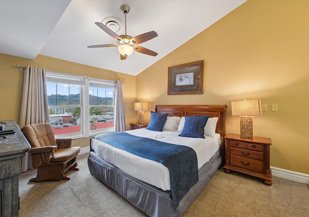 Sink into comfort in your cozy bedroom, complete with mountain views and a gentle ceiling fan to keep you cool.