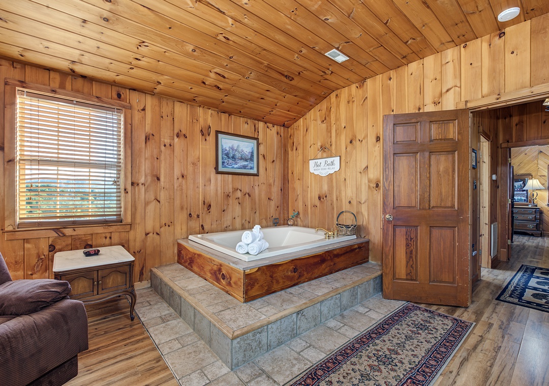 Sink into your private hot tub surrounded by warm knotty pine walls—your perfect retreat for unwinding after a day of mountain adventures.