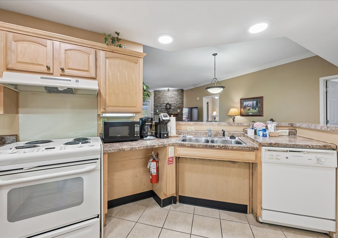 Your fully equipped kitchen features granite countertops, warm wood cabinets, and all appliances needed to create memorable meals during your stay.