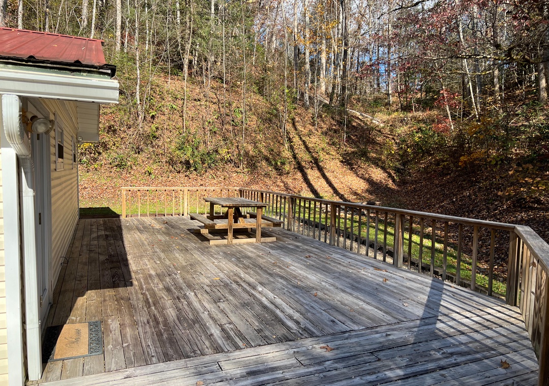 Your private deck offers peaceful woodland views where you can unwind surrounded by autumn colors and natural tranquility.