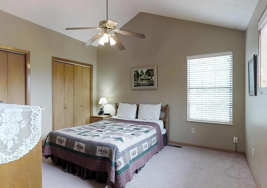 Your comfortable bedroom offers a peaceful retreat with fresh linens, vaulted ceilings, ceiling fan, and natural light to help you unwind after exploring the area.