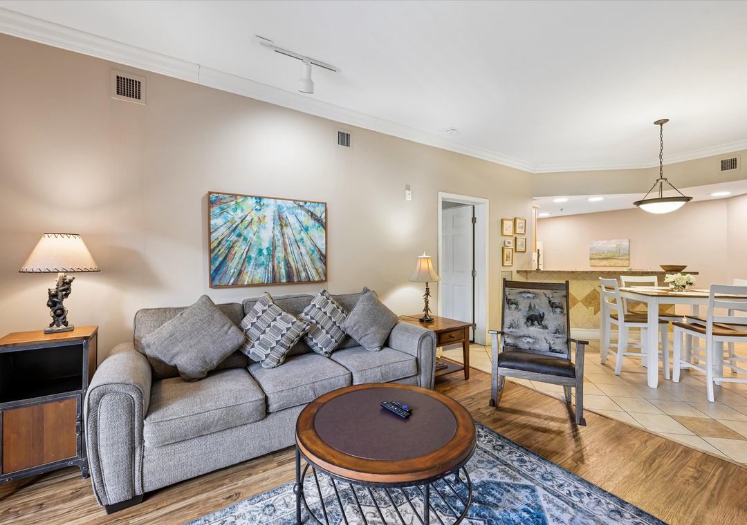 Unwind on your cozy sectional sofa while warm lighting creates the perfect ambiance for evening relaxation in this stylishly appointed living space.