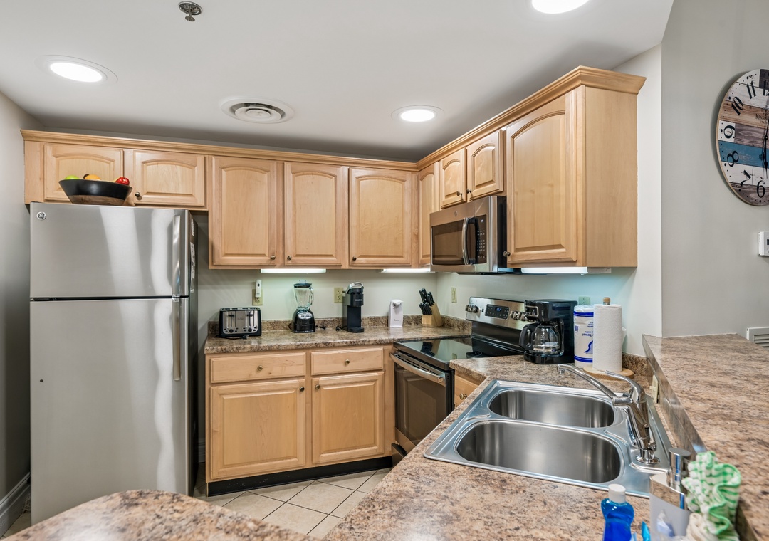 Cook your favorite meals in this fully equipped kitchen featuring granite counters, stainless appliances, and everything you need for home comfort.