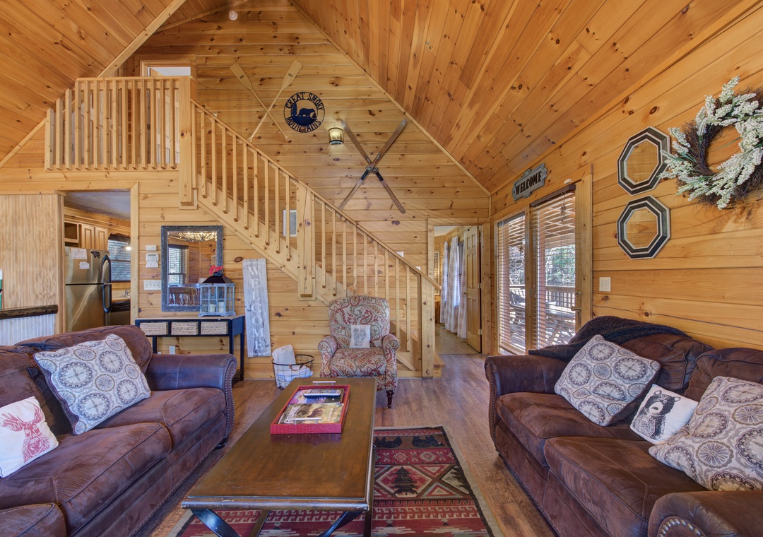 Step into your cozy cabin retreat where warm wood surrounds you, plush leather sofas invite relaxation, and rustic charm creates the perfect mountain getaway.
