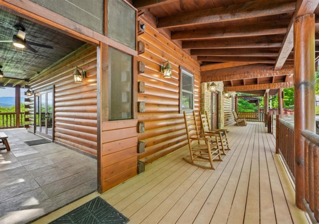 Spacious wraparound porch invites relaxation with rocking chairs and scenic mountain vistas, perfect for sipping morning coffee or unwinding after exploring the area.