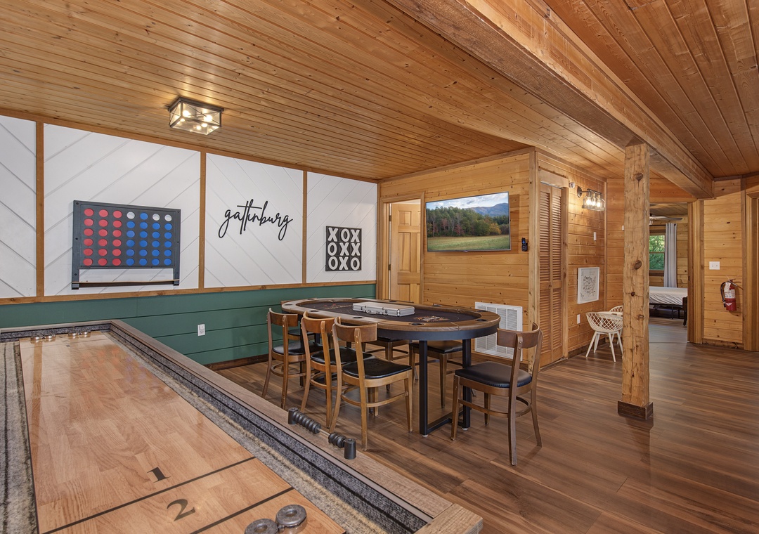 Step into your own private game room with rustic wood beams, shuffleboard, classic board games, and cozy seating—perfect for gathering with friends and family.