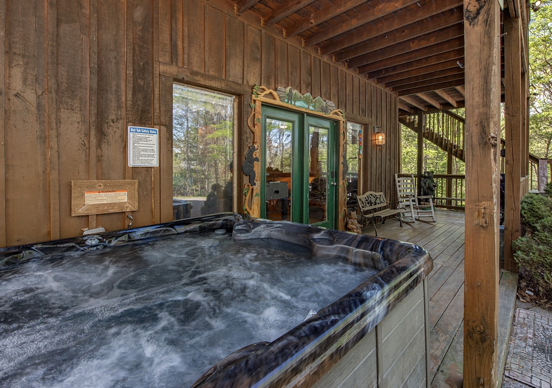 Unwind in your private hot tub on the covered deck, surrounded by peaceful forest views and rustic charm.